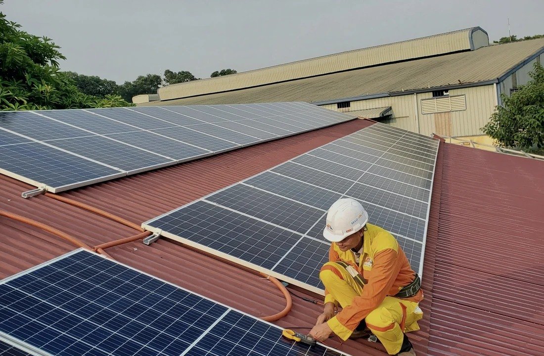 Engineer inspecting a commercial rooftop solar system
